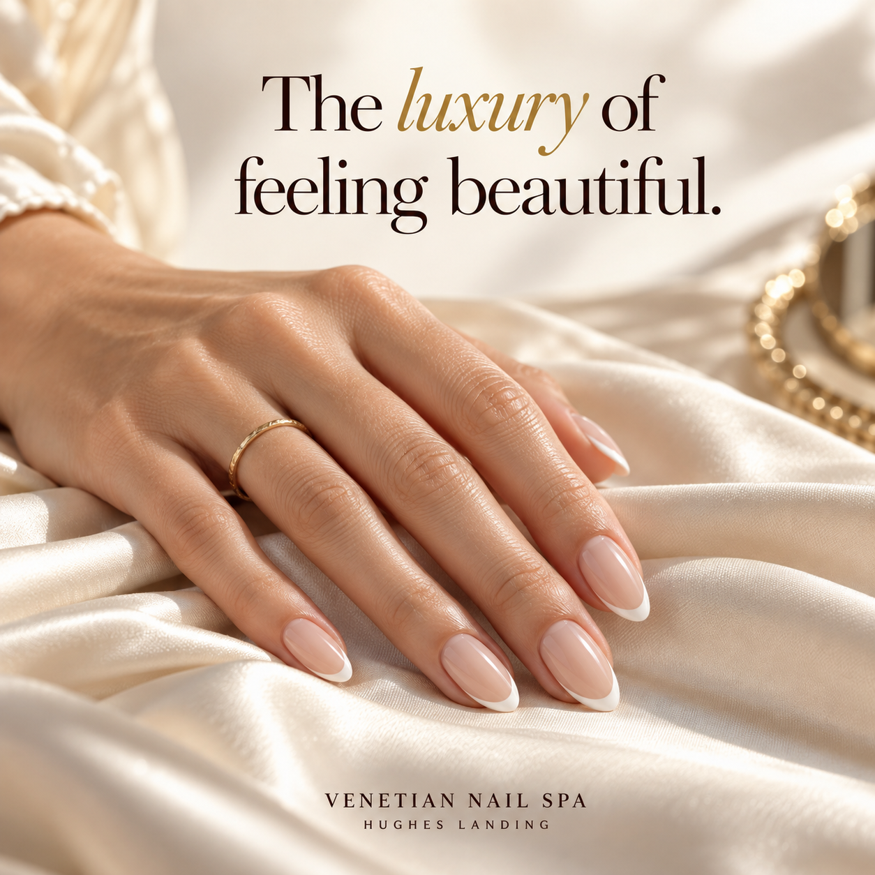 French manicure on ivory silk with the slogan The luxury of feeling beautiful.